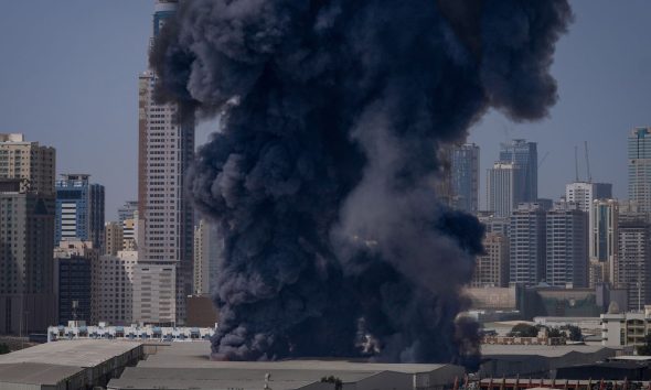Smoke rises after a strike on a warehouse in Sharjah City in Dubai. Pic: AP