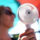 A woman cools herself with a hand fan in Hamburg during a heatwave in Germany in July 2025. Pic: AP