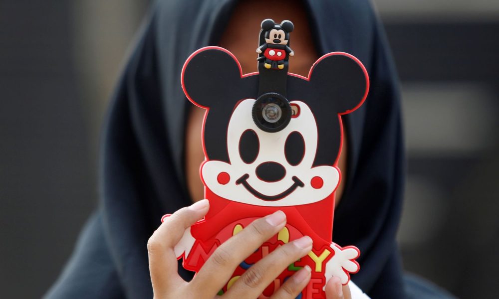 A girl takes a picture using her phone in a park in Jakarta, Indonesia. File pic: Reuters