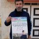 Khalid Ahmad holding a poster of his son, Walid Ahmad, who died in an Israeli prison. Pic: AP
