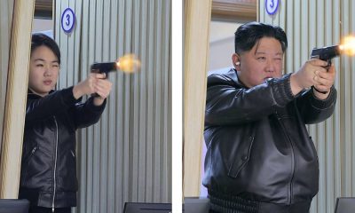 Kim Jong Un and Kim Ju Ae fire pistols as they visit a munitions factory. Pic: Reuters