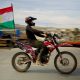 A biker proudly displays a Kurdistan flag