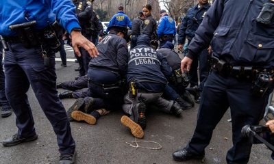 Counter-protester arrested by the NYPD. Pic: Reuters