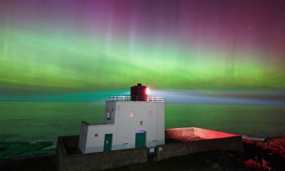 The aurora borealis above Bamburgh Lighthouse in Northumberland. Pic: PA