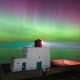 The aurora borealis above Bamburgh Lighthouse in Northumberland. Pic: PA