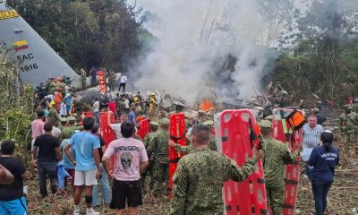 People gathered to help at the wreckage site. Pic: AP