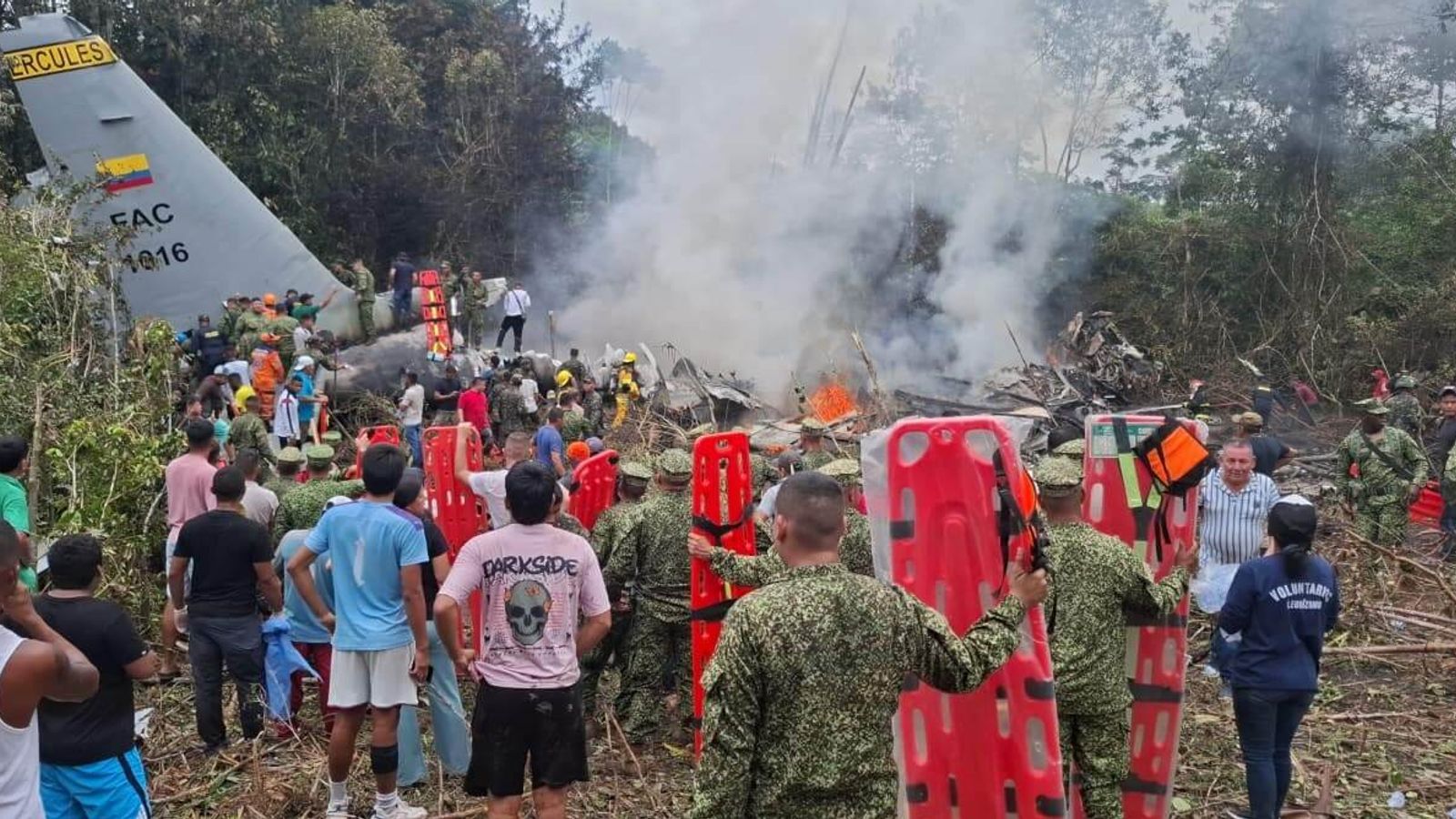 People gathered to help at the wreckage site. Pic: AP