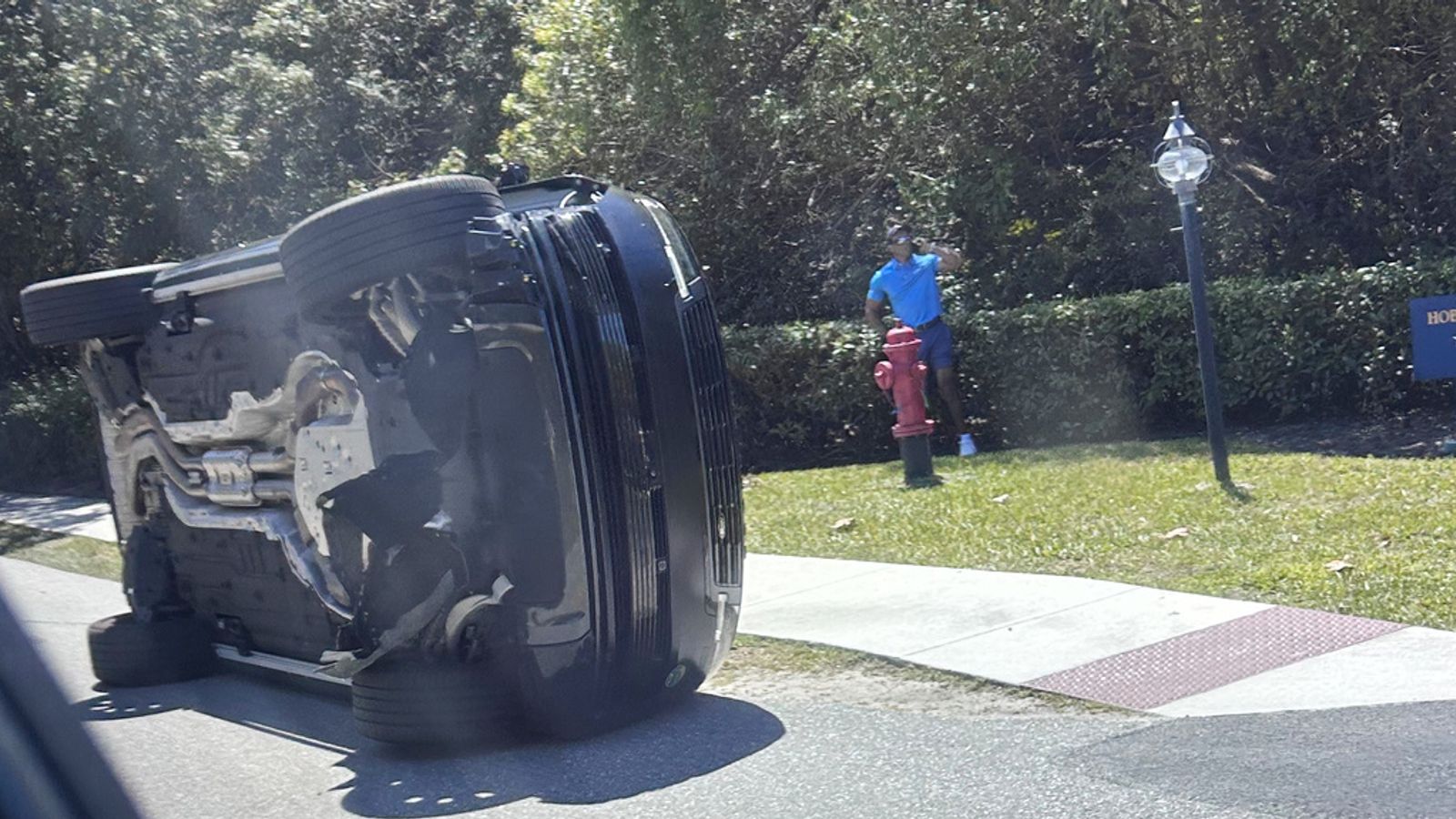 Tiger Woods standing near his overturned vehicle in Jupiter Island, Florida. Pic: AP