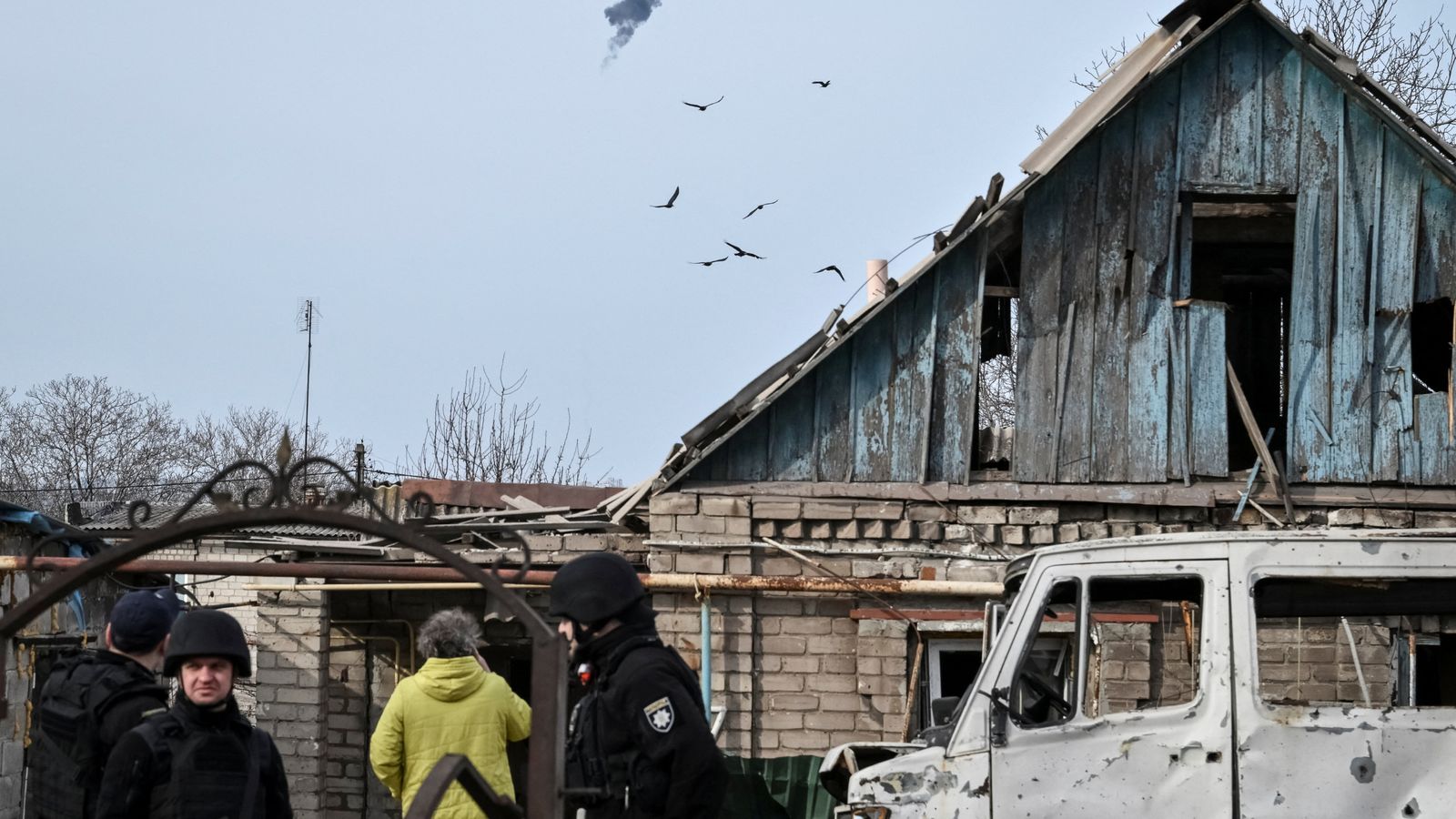 Police officers work at the site of a building hit by a Russian drone strike. Pic: Reuters