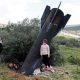 A girl stands next to the remnants of a missile in Kifl Haris village in the West Bank. Pic: Reuters