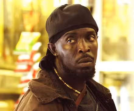 Michael K Williams looking to the side with a serious expression in The Wire.