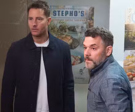 Justin Hartley wears a blue jacket and a white tee shirt in a 'Tracker' image