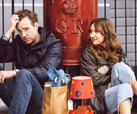 Rafe Spall and Esther Smith in Apple TV+'s Trying sitting down on the floor next to each other.
