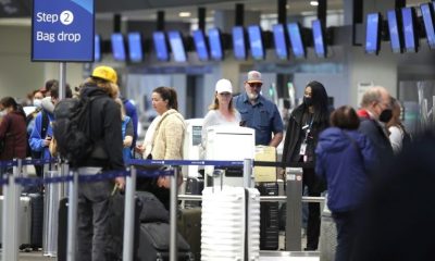 United Airlines passengers check in for flights at San Francisco International Airport on April 19, 2022