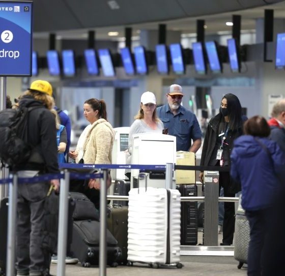 United Airlines passengers check in for flights at San Francisco International Airport on April 19, 2022