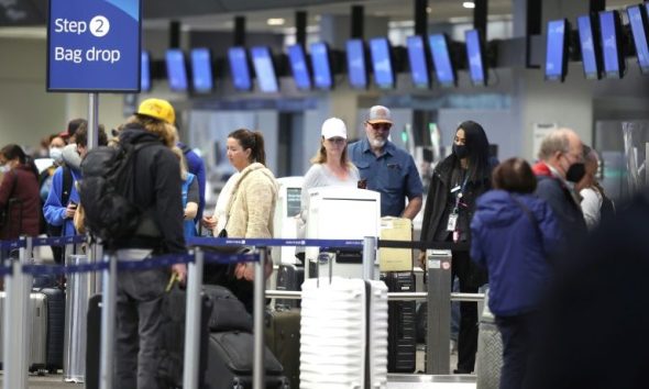 United Airlines passengers check in for flights at San Francisco International Airport on April 19, 2022