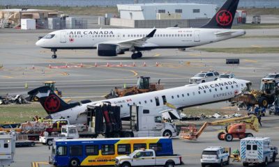 Mangled plane involved in LaGuardia crash is towed from runway