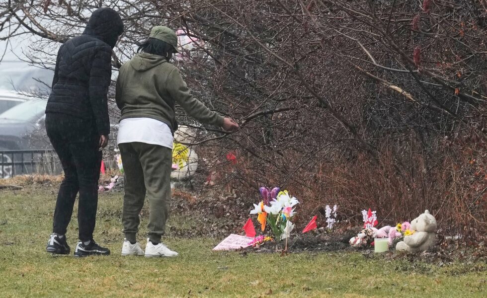 Mother of 2 girls found in shallow graves charged with murder