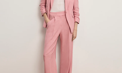woman wears pale dusty pink pantsuit