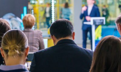 corporate women and men sit in a professional conference
