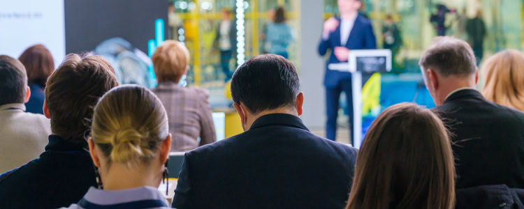 corporate women and men sit in a professional conference