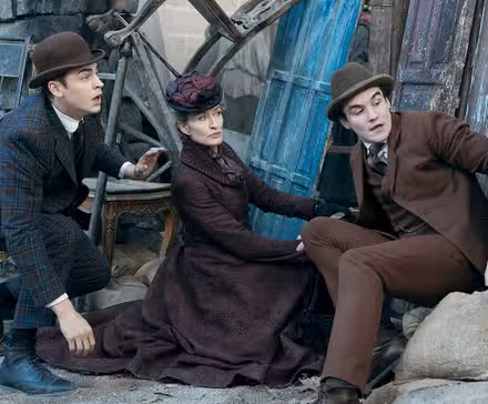 Hero Fiennes Tiffin as Sherlock hiding outside with Natascha McElhone and Dónal Finn in Young Sherlock