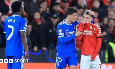 SL Benfica's Argentine forward Gianluca Prestianni hides his mouth while arguing with Real Madrid's Brazilian forward Vinicius Junior