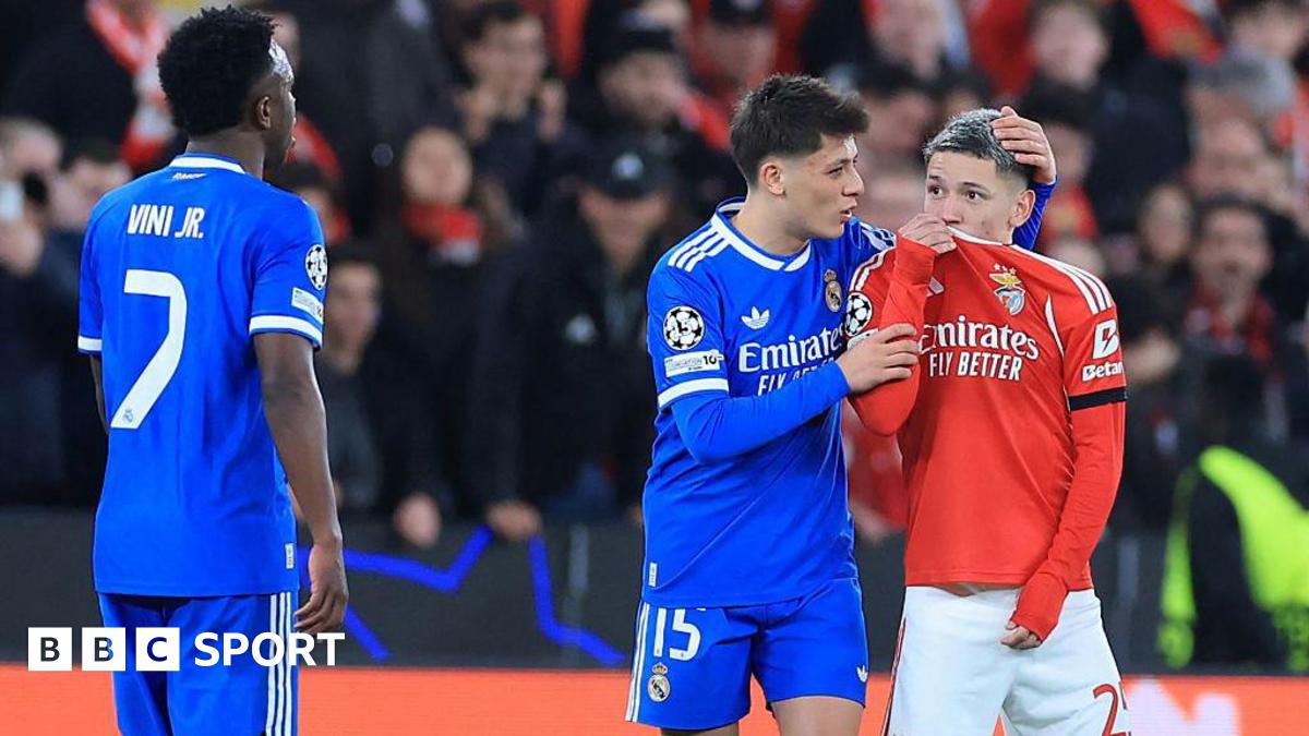 SL Benfica's Argentine forward Gianluca Prestianni hides his mouth while arguing with Real Madrid's Brazilian forward Vinicius Junior