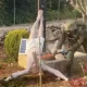 An Israeli soldier takes a sledgehammer to the face of a crucified Jesus Christ statue, which is on the ground. Taken from a BBC News report