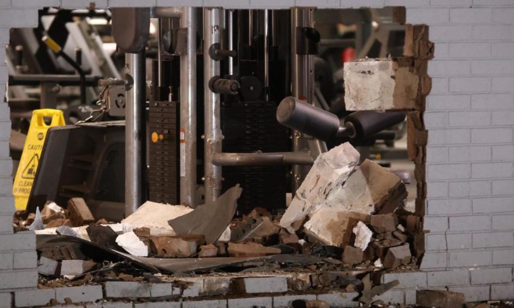 Car recovered after crashing through gym wall leaves large hole