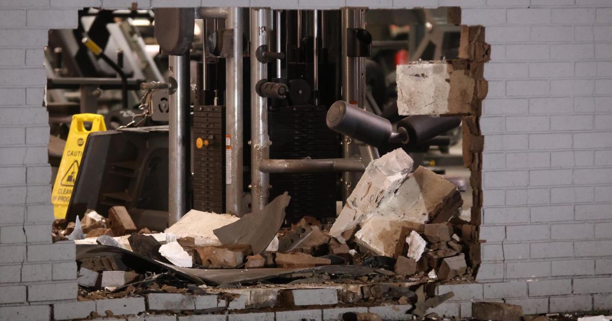 Car recovered after crashing through gym wall leaves large hole