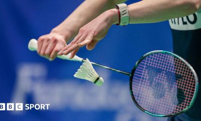 Badminton player serves a shuttlecock