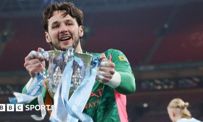 James Trafford holds the Carabao Cup trophy