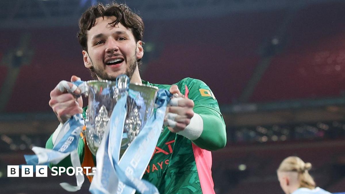 James Trafford holds the Carabao Cup trophy