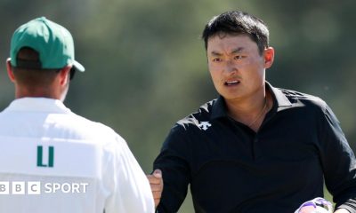 Li Haotong fist bumps his caddie at the 2026 Masters