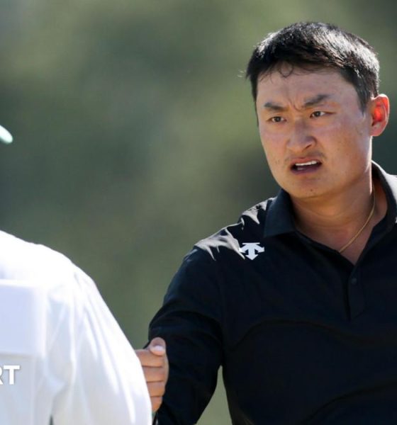 Li Haotong fist bumps his caddie at the 2026 Masters