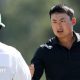 Li Haotong fist bumps his caddie at the 2026 Masters
