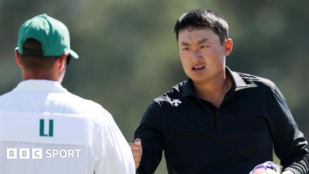 Li Haotong fist bumps his caddie at the 2026 Masters