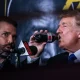 President Donald Trump drinks a soda as he hosts the Holyfield vs Belford boxing match live in 2021, next to his son Donald Trump Jr.