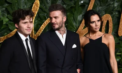 Brooklyn Peltz Beckham with his parents, Sir David and Victoria Beckham, in 2018.