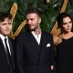 Brooklyn Peltz Beckham with his parents, Sir David and Victoria Beckham, in 2018.