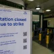 A sign reading 'Station closed due to strike' is placed inside Covent Garden Underground station, in London, Tuesday, June 21, 2022. Tens of thousands of railway workers walked off the job in Britain on Tuesday, bringing the train network to a crawl in the country's biggest transit strike for three decades. (AP Photo/Alberto Pezzali)