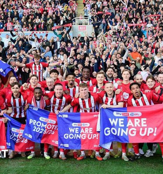 The Lincoln City squad celebrating their promotion infront of their visiting supporters at Reading's Select Car Leasing Stadium.