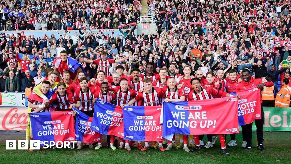 The Lincoln City squad celebrating their promotion infront of their visiting supporters at Reading's Select Car Leasing Stadium.