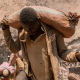 An artisanal miner carries a sack of ore at the Shabara artisanal mine near Kolwezi, DRC, on Oct. 12, 2022.