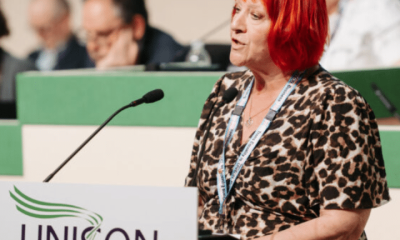 Andrea Egan speaking at the 2026 Unison health conference wearing her Unison lanyard and standing infront of a mic
