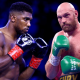Anthony Joshua (left) and Tyson Fury (right) hold their gloves up in a defence stance, bare chested, in separate images that have been edited to be side by side
