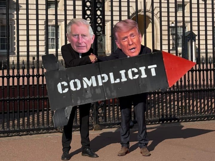 Protesters against Charles's state visit to Trump wear Charles and Trump masks and hold a prop missile saying COMPLICIT in front of Buckingham Palace