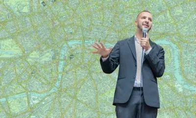 Zack Polanski in front of a green map of London