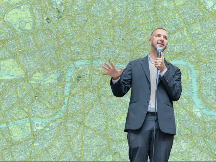 Zack Polanski in front of a green map of London